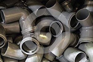 Plastic pipe bends in a pile. Industrial products for construction
