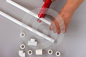 Plastic pipes for the water system on grey background. Repair service, sale, online. Flat lay. Copy space