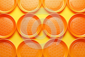 Plastic plates on color background, top view