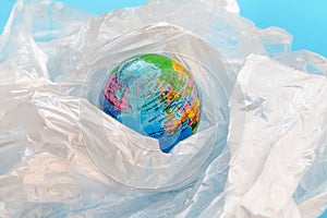 Plastic pollution concept with the planet earth floating in plastic bags