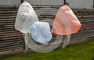 Plastic pollution of the environment with disposable multi-colored bags, horizontal