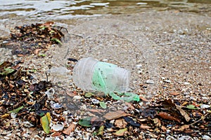 Plastic pollution environmental problem on the beach of the big city. Empty used dirty plastic.