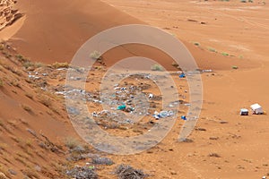 Plastic pollution and garbage dumping in the desert sand. Need for awareness of environmental protection, recycling, and