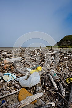 Plastic pollution nets bottles furniture foam on ocean beach
