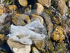 Plastic pollution in river background. Environmental issues. Stock photo.