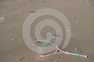 Plastic racket sea pollution on sandy beach ecosystem,garbage on sea coast