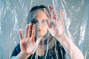 Plastic pollution woman hands polyethylene film