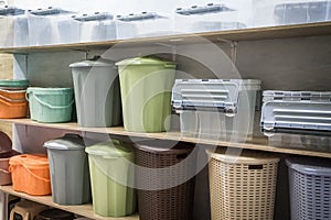 Plastic products containers boxes baskets for storage and organization of space and interior on the shelf in the store