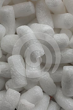 Plastic protective foam background and texture. Macro view of white packing foam background. Bubbly plastic protective granules.