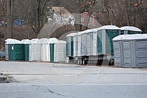 Collection of porta potties in parking lot photo