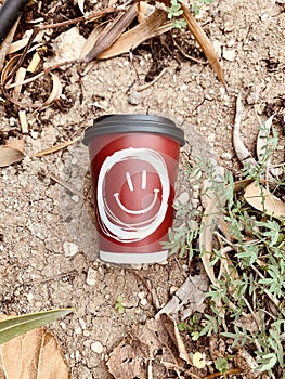 plastic red cup with smile on the ground