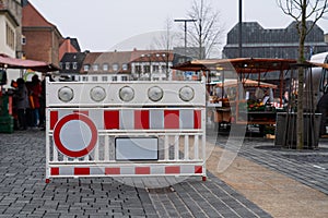 Plastic red and white barrier with a stop signal fume resurrecting entry to the peasant market photo