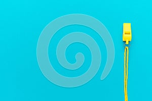 Plastic referee whistle on turquoise blue background