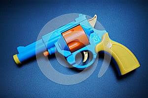 Plastic revolver toys on black background