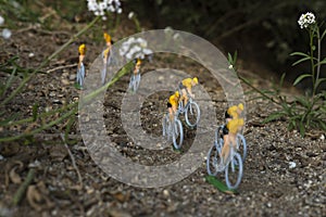 Plastic yellow road cyclists outdoor in the bushes. Competition. Peloton. photo