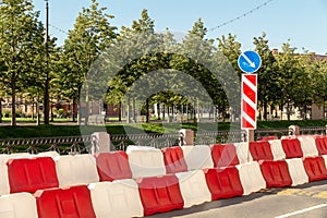 Plastic road fence on the street of the city. red and white water blocks to restrict traffic during road works.