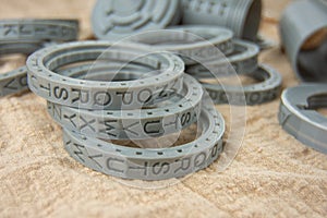 Plastic round letters rings printed on a 3D printer for cryptex printed by FDM technology with gray filament.