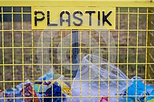 Plastic rubish collection recycling bin on a street