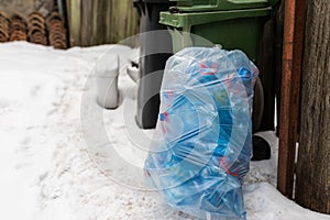 Plastic sack filled with blue plastic mineral water bottles