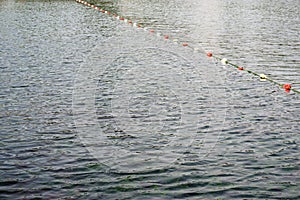 Plastic safety buoys floating on waves at sea.