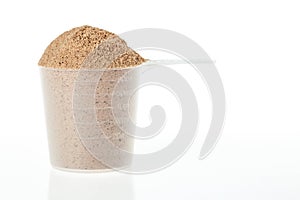 Plastic scoop of chocolate whey isolate protein