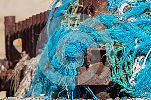 Plastic sea pollution. Tangled nylon fishing net caught up on a