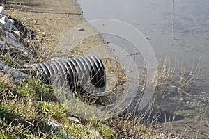 Plastic sewage pipe on a small stream