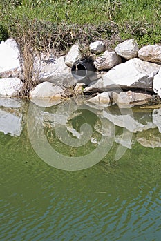 Plastic sewage pipe on a small stream