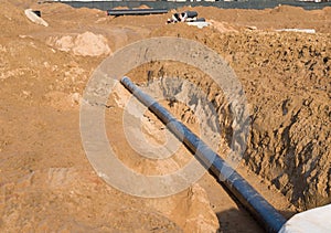 Plastic sewer pipe in trench for laying an external sewage system at a construction site. Sanitary drainage system for a multi-