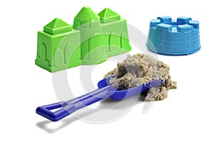 Plastic Shovel With Sand and Colored Molds On White Background