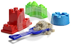 Plastic Shovel With Sand and Colored Molds On White Background