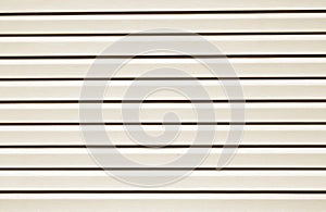 Plastic siding surface in brown tone.