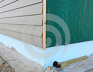 Plastic Siding Wall Construction and Insulation Membrane on House Exterior Wall.