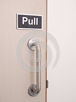 Plastic sign Pull at a door with handle
