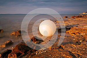 plastic signal buoy on the sea shore. Sunrise over the sea