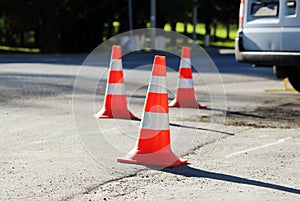 plastic signaling traffic cone encloses a place in the parking lot for trucks