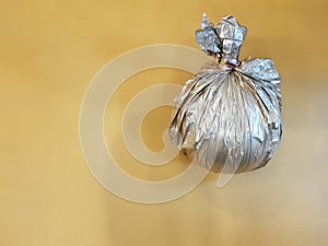 A plastic silver bag with a filler serves as a ballast for inflatable balloons for the holiday.
