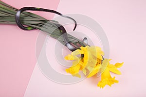 a plastic snake wrapped around a bouquet of daffodils