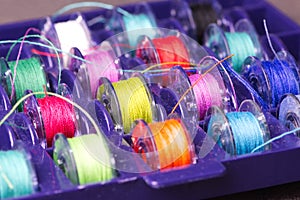 Plastic spools with colored yarn