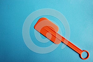 Plastic spoon on blue background