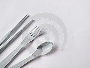 plastic spoon, fork and chopsticks on white background