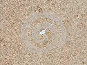 Plastic spoon pollution on sea beach endangering marine life