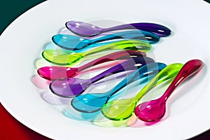 Lots of bright colourful plastic spoons.