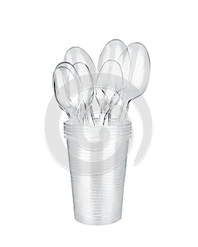 Plastic spoons in plastic cups stack white background isolated closeup, transparent plastic drinking glass for water, coffee, tea