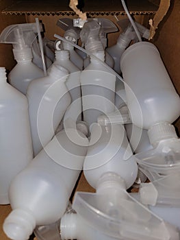 Plastic spray bottles in cardboard box