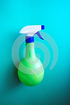 Plastic spray yellow bottle isolated on blue background