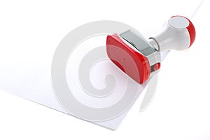Plastic stamp over white paper