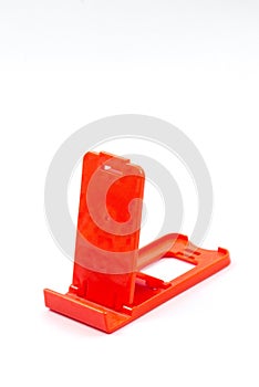 Plastic standing assistant for mobile phone isolated from the white background.