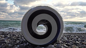 An plastic storm drain pipe on the the sea backgound. Video about waste water resources. Sea, ocean, water pollution