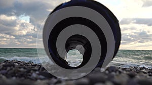 An plastic storm drain pipe on the the sea backgound. Video about waste water resources. Sea, ocean, water pollution